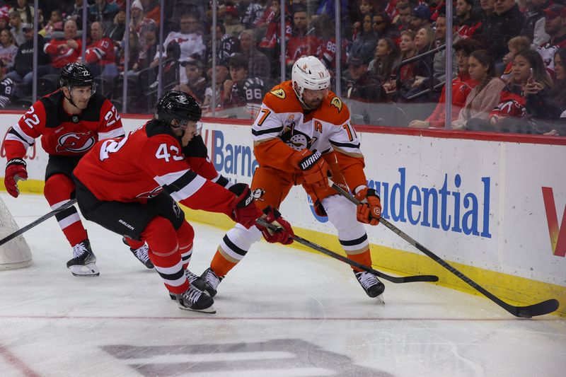 Oct 27, 2024; Newark, New Jersey, USA; Anaheim Ducks left wing Alex Killorn (17) skates with the puck while being defended by New Jersey Devils defenseman Luke Hughes (43) during the first period at Prudential Center. Mandatory Credit: Ed Mulholland-Imagn Images