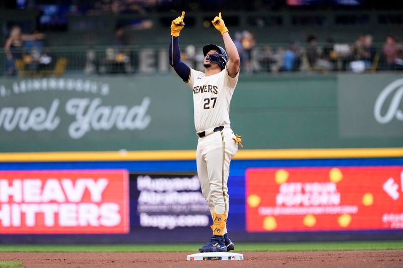 Jul 10, 2024; Milwaukee, Wisconsin, USA;  Milwaukee Brewers shortstop Willy Adames (27) celebrates at second base after hitting an RBI double during the first inning against the Pittsburgh Pirates at American Family Field. Mandatory Credit: Jeff Hanisch-USA TODAY Sports