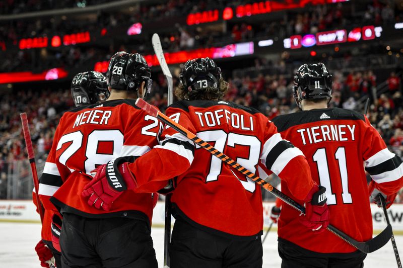 Feb 24, 2024; Newark, New Jersey, USA; New Jersey Devils right wing Timo Meier (28) celebrates with teammates after scoring a goal against the Montreal Canadiens during the second period at Prudential Center. Mandatory Credit: John Jones-USA TODAY Sports