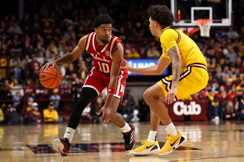 Jan 24, 2026; Minneapolis, Minnesota, USA; Nebraska Cornhuskers guard Jamarques Lawrence (10) dribbles the ball as Minnesota Golden Gophers guard Kai Shinholster (9) defends during the second half at Williams Arena. Mandatory Credit: Matt Krohn-Imagn Images