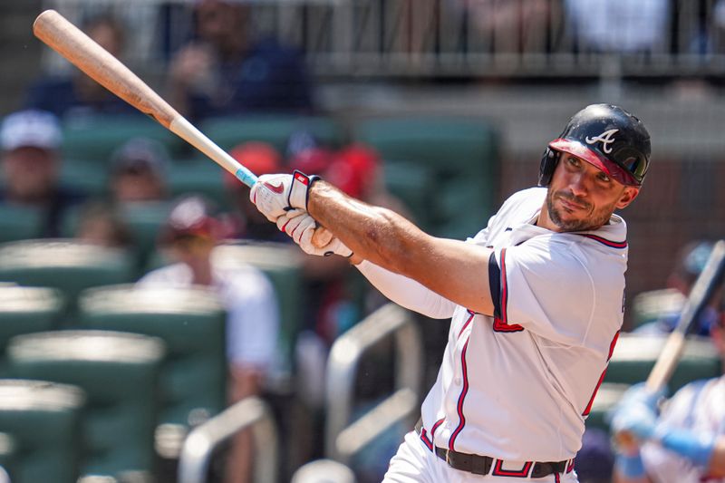 Jun 16, 2024; Cumberland, Georgia, USA; Atlanta Braves first baseman Matt Olson (28) hits a double against the Tampa Bay Rays during the eighth inning at Truist Park. Mandatory Credit: Dale Zanine-USA TODAY Sports