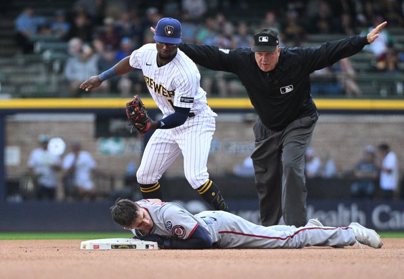 Sep 17, 2023; Milwaukee, Wisconsin, USA; Washington Nationals catcher Drew Millas (81) slides in safely ahead of the tag by Milwaukee Brewers second baseman Andruw Monasterio (14) in the eighth inning at American Family Field. Mandatory Credit: Michael McLoone-USA TODAY Sports