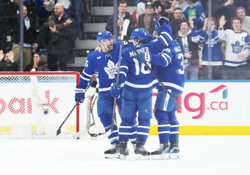 Feb 15, 2024; Toronto, Ontario, CAN; Toronto Maple Leafs center Auston Matthews (34) scores his second goal and celebrates with right wing Mitchell Marner (16) against the Philadelphia Flyers during the second period at Scotiabank Arena. Mandatory Credit: Nick Turchiaro-USA TODAY Sports