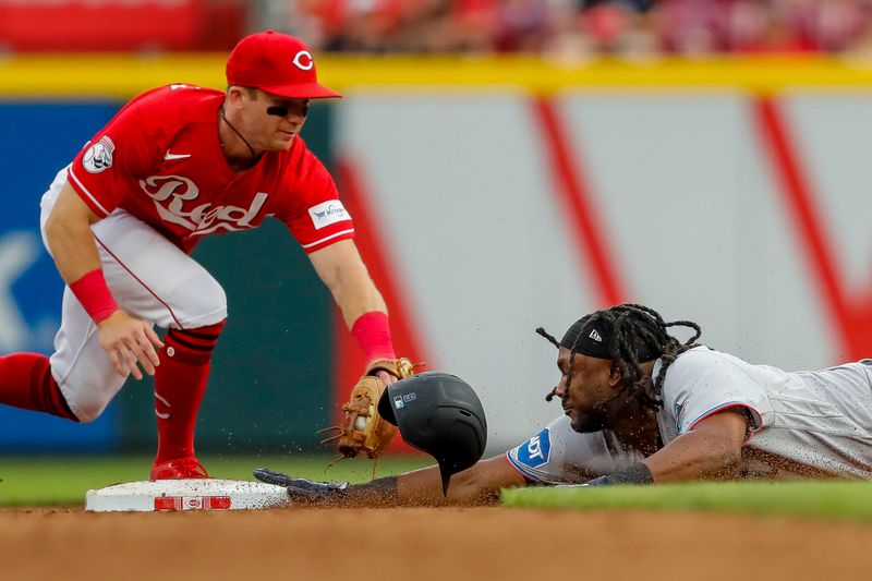 Aug 8, 2023; Cincinnati, Ohio, USA; Miami Marlins first baseman Josh Bell (9) slides into second after hitting a double against Cincinnati Reds second baseman Matt McLain (9) in the sixth inning at Great American Ball Park. Mandatory Credit: Katie Stratman-USA TODAY Sports
