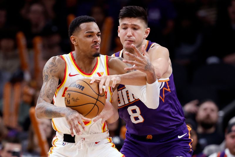 PHOENIX, ARIZONA - MARCH 21: Grayson Allen #8 of the Phoenix Suns pressures Dejounte Murray #5 of the Atlanta Hawks during the second half at Footprint Center on March 21, 2024 in Phoenix, Arizona. NOTE TO USER: User expressly acknowledges and agrees that, by downloading and or using this photograph, User is consenting to the terms and conditions of the Getty Images License Agreement.  (Photo by Chris Coduto/Getty Images)