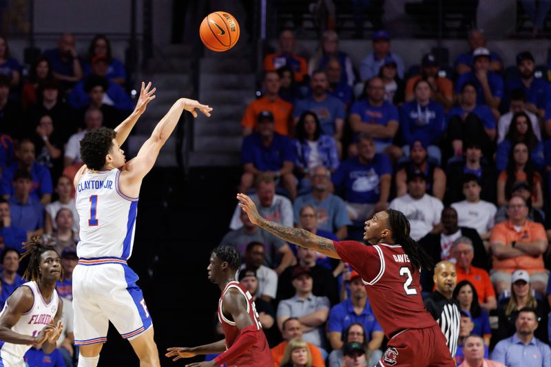Feb 15, 2025; Gainesville, Florida, USA; Florida Gators guard Walter Clayton Jr. (1) shoots over South Carolina Gamecocks guard Zachary Davis (2) during the first half at Exactech Arena at the Stephen C. O'Connell Center. Mandatory Credit: Matt Pendleton-Imagn Images