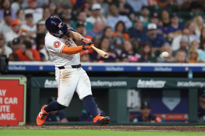 May 24, 2025; Houston, Texas, USA; Houston Astros second baseman Jose Altuve (27) hits a single during the third inning against the Seattle Mariners at Daikin Park. Mandatory Credit: Troy Taormina-Imagn Images