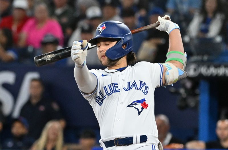 Sep 27, 2023; Toronto, Ontario, CAN;  Toronto Blue Jays shortstop Bo Bichette (11) strikes out swinging against the New York Yankees in the first inning at Rogers Centre. Mandatory Credit: Dan Hamilton-USA TODAY Sports