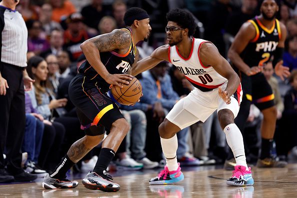 PHOENIX, ARIZONA - JANUARY 01: Bradley Beal #3 of the Phoenix Suns controls the ball against Scoot Henderson #00 of the Portland Trail Blazers during the game at Footprint Center on January 01, 2024 in Phoenix, Arizona. The Suns defeated the Trail Blazers 109-88. NOTE TO USER: User expressly acknowledges and agrees that, by downloading and or using this photograph, User is consenting to the terms and conditions of the Getty Images License Agreement.  (Photo by Chris Coduto/Getty Images)