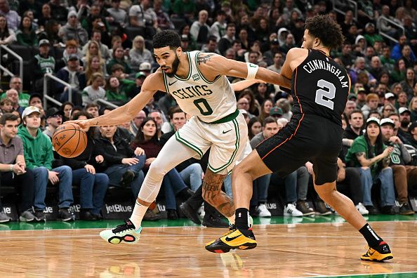 BOSTON, MASSACHUSETTS - DECEMBER 28: Jayson Tatum #0 of the Boston Celtics drives to the basket against Cade Cunningham #2 of the Detroit Pistons during the second quarter at TD Garden on December 28, 2023 in Boston, Massachusetts. NOTE TO USER: User expressly acknowledges and agrees that, by downloading and or using this photograph, User is consenting to the terms and conditions of the Getty Images License Agreement. (Photo by Brian Fluharty/Getty Images)