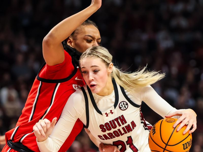 Feb 18, 2024; Columbia, South Carolina, USA; South Carolina Gamecocks forward Chloe Kitts (21) drives around Georgia Lady Bulldogs forward Destiny Thomas (33) in the first half at Colonial Life Arena. Mandatory Credit: Jeff Blake-USA TODAY Sports