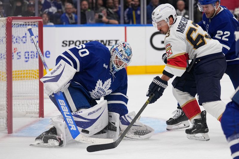 May 14, 2025; Toronto, Ontario, CAN; Toronto Maple Leafs goaltender Joseph Woll (60) makes a save against Florida Panthers forward Brad Marchand (63) during the second period of game five of the second round of the 2025 Stanley Cup Playoffs at Scotiabank Arena. Mandatory Credit: John E. Sokolowski-Imagn Images