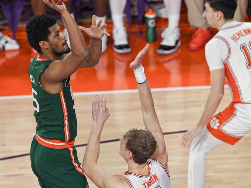 Feb 4, 2023; Clemson, South Carolina, USA; Miami guard Harlond Beverly (5) shoots near Clemson forward Hunter Tyson (5) during the first half at Littlejohn Coliseum in Clemson, S.C. Saturday, Feb. 4, 2023.  Mandatory Credit: Ken Ruinard-USA TODAY Sports