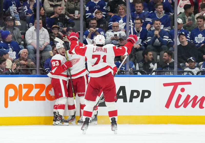 Apr 13, 2024; Toronto, Ontario, CAN; Detroit Red Wings right wing Alex DeBrincat (93) scores a goal and celebrates with Detroit Red Wings center Dylan Larkin (71) during the first period against the Toronto Maple Leafs at Scotiabank Arena. Mandatory Credit: Nick Turchiaro-USA TODAY Sports