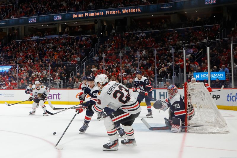 Mar 9, 2024; Washington, District of Columbia, USA; Chicago Blackhawks center Philipp Kurashev (23) passes the puck tp Blackhawks center Connor Bedard (98) as Washington Capitals defenseman John Carlson (74) defends at Capital One Arena. Mandatory Credit: Geoff Burke-USA TODAY Sports