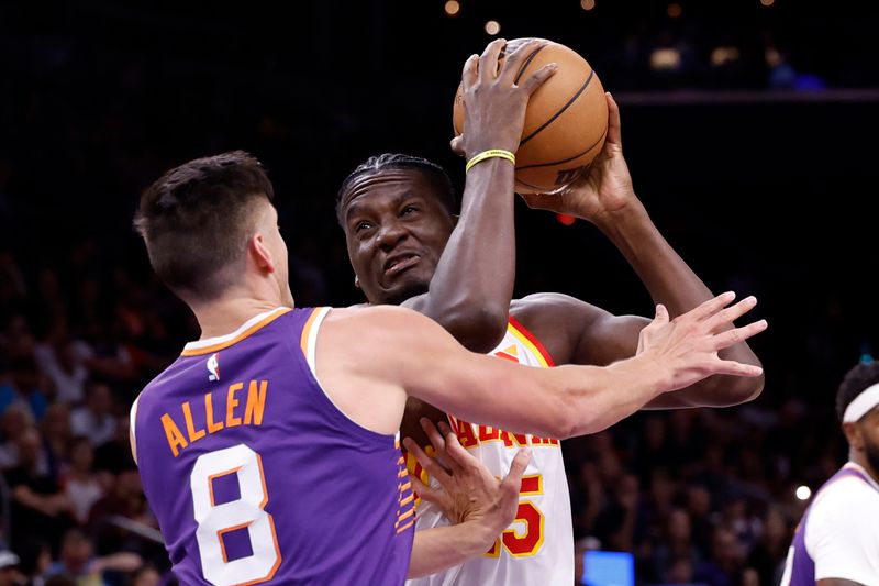 PHOENIX, ARIZONA - MARCH 21: Clint Capela #15 of the Atlanta Hawks drives to the basket against Grayson Allen #8 of the Phoenix Suns during the first half at Footprint Center on March 21, 2024 in Phoenix, Arizona. NOTE TO USER: User expressly acknowledges and agrees that, by downloading and or using this photograph, User is consenting to the terms and conditions of the Getty Images License Agreement.  (Photo by Chris Coduto/Getty Images)