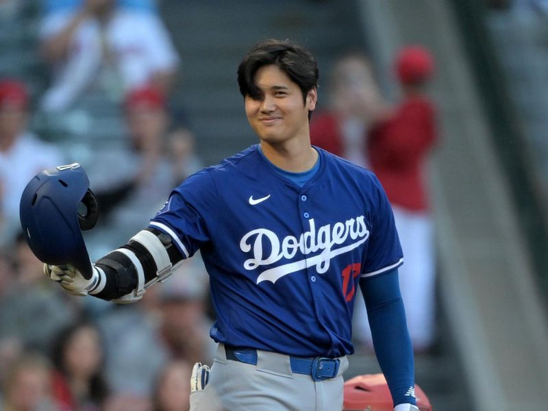Mar 26, 2024; Anaheim, California, USA; Los Angeles Dodgers designated hitter Shohei Ohtani (17) acknowledges the crowd prior to his first at bat in the first inning against the Los Angeles Angels at Angel Stadium. Mandatory Credit: Jayne Kamin-Oncea-USA TODAY Sports