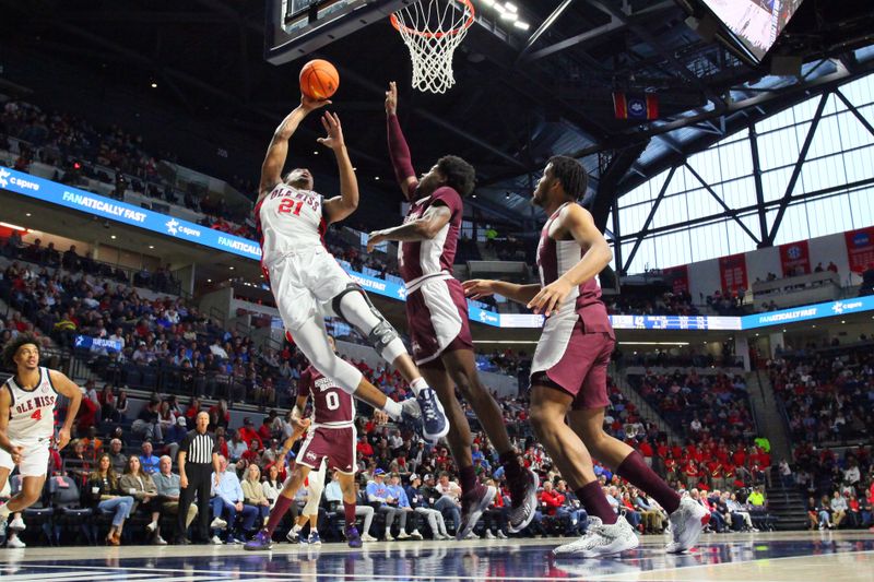 Feb 18, 2023; Oxford, Mississippi, USA; Mississippi Rebels forward Robert Allen (21) shoots as Mississippi State Bulldogs guard/forward Cameron Matthews (4) defends during the second half at The Sandy and John Black Pavilion at Ole Miss. Mandatory Credit: Petre Thomas-USA TODAY Sports