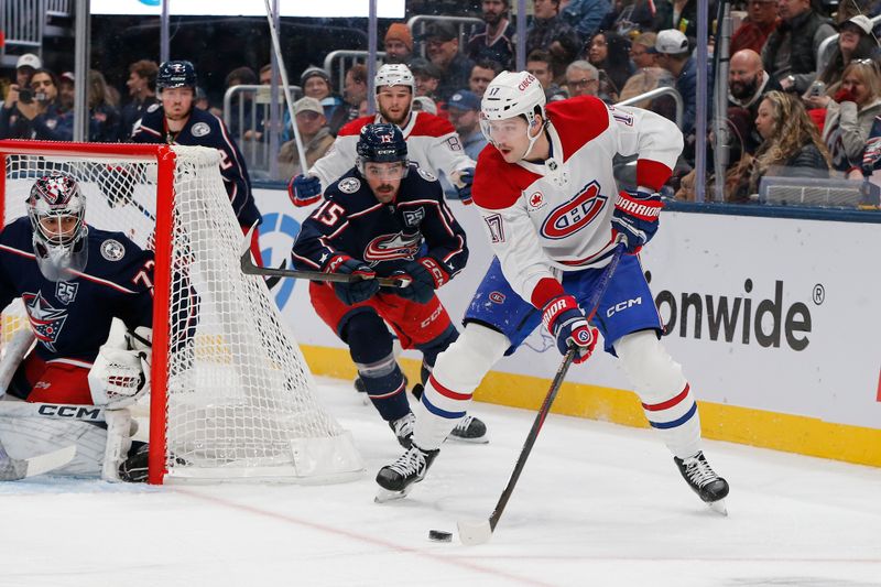 Nov 17, 2025; Columbus, Ohio, USA; Montreal Canadiens right wing Josh Anderson (17) passes the puck as Columbus Blue Jackets defenseman Dante Fabbro (15) trails the play during the first period at Nationwide Arena. Mandatory Credit: Russell LaBounty-Imagn Images