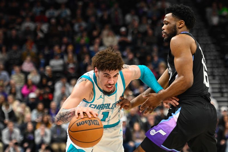 SALT LAKE CITY, UTAH - JANUARY 15: LaMelo Ball #1 of the Charlotte Hornets drives into Elijah Harkless #16 of the Utah Jazz during the first half of a game at Delta Center on January 15, 2025 in Salt Lake City, Utah. NOTE TO USER: User expressly acknowledges and agrees that, by downloading and or using this photograph, User is consenting to the terms and conditions of the Getty Images License Agreement. (Photo by Alex Goodlett/Getty Images)