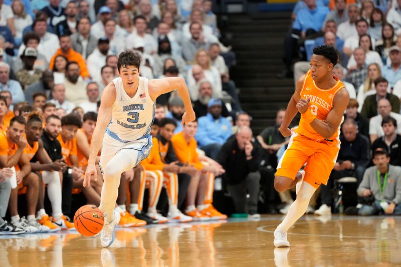 Nov 29, 2023; Chapel Hill, North Carolina, USA; North Carolina Tar Heels guard Cormac Ryan (3) on the fast break as Tennessee Volunteers guard Dalton Knecht (3) defends in the second half at Dean E. Smith Center. Mandatory Credit: Bob Donnan-USA TODAY Sports