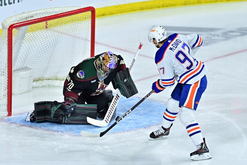 Mar 27, 2023; Tempe, Arizona, USA;  Arizona Coyotes goaltender Karel Vejmelka (70) makes a save on Edmonton Oilers center Connor McDavid (97) in th first period at Mullett Arena. Mandatory Credit: Matt Kartozian-USA TODAY Sports