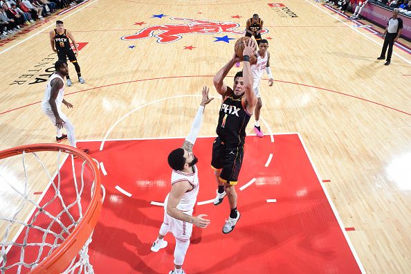 HOUSTON, TX - DECEMBER 27:   Devin Booker #1 of the Phoenix Suns shoots the ball during the game against the Houston Rockets on December 27, 2023 at the Toyota Center in Houston, Texas. NOTE TO USER: User expressly acknowledges and agrees that, by downloading and or using this photograph, User is consenting to the terms and conditions of the Getty Images License Agreement. Mandatory Copyright Notice: Copyright 2023 NBAE (Photo by Logan Riely/NBAE via Getty Images)