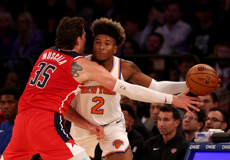 NEW YORK, NEW YORK - OCTOBER 18: Miles McBride #2 of the New York Knicks tries to pass as Mike Muscala #35 of the Washington Wizards defends during a preseason game at Madison Square Garden on October 18, 2023 in New York City. NOTE TO USER: User expressly acknowledges and agrees that, by downloading and or using this photograph, User is consenting to the terms and conditions of the Getty Images License Agreement. (Photo by Elsa/Getty Images)