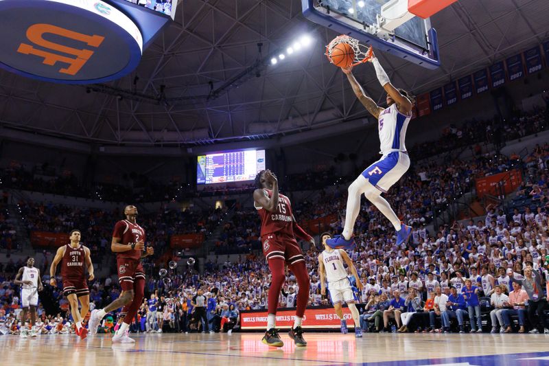 Feb 15, 2025; Gainesville, Florida, USA; Florida Gators guard Will Richard (5) dunks the ball over South Carolina Gamecocks guard Morris Ugusuk (15) during the second half at Exactech Arena at the Stephen C. O'Connell Center. Mandatory Credit: Matt Pendleton-Imagn Images