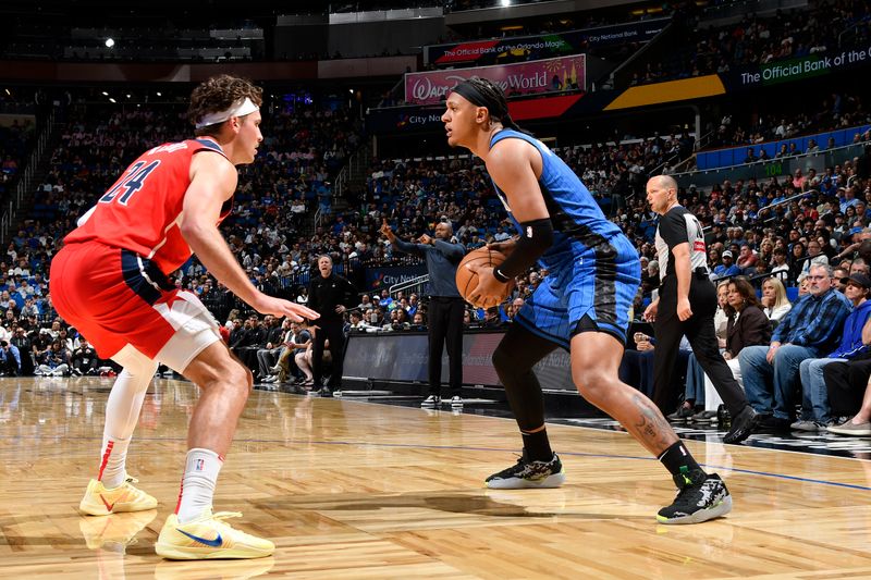 ORLANDO, FL - FEBRUARY 23:  Paolo Banchero #5 of the Orlando Magic handles the ball during the game against the Washington Wizards on February 23, 2025 at Kia Center in Orlando, Florida. NOTE TO USER: User expressly acknowledges and agrees that, by downloading and or using this photograph, User is consenting to the terms and conditions of the Getty Images License Agreement. Mandatory Copyright Notice: Copyright 2025 NBAE (Photo by Fernando Medina/NBAE via Getty Images)