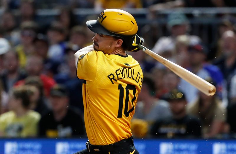 May 24, 2024; Pittsburgh, Pennsylvania, USA;  Pittsburgh Pirates left fielder Bryan Reynolds (10) hits an infield single against the Atlanta Braves during the seventh inning at PNC Park. Mandatory Credit: Charles LeClaire-USA TODAY Sports