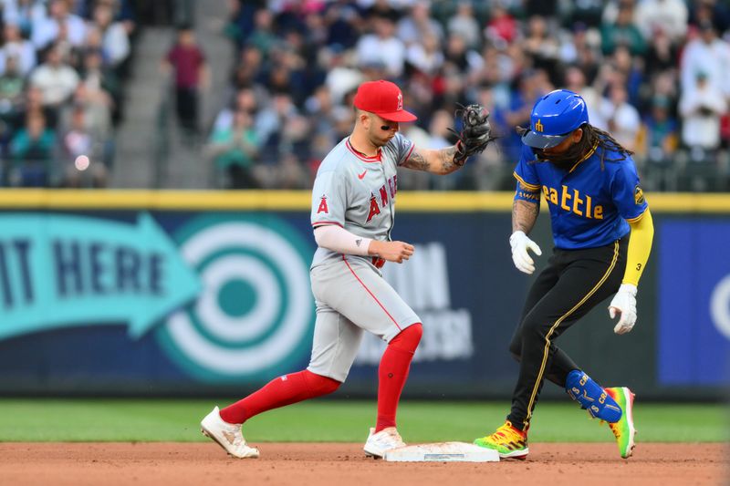 May 31, 2024; Seattle, Washington, USA; Seattle Mariners shortstop J.P. Crawford (3) beats Los Angeles Angels shortstop Zach Neto (9) to second base after hitting a double during the fifth inning at T-Mobile Park. Mandatory Credit: Steven Bisig-USA TODAY Sports