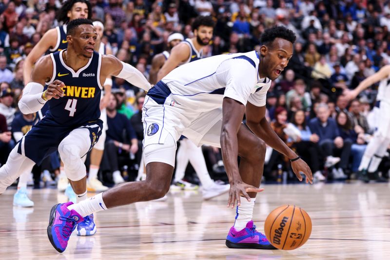 DENVER, COLORADO - NOVEMBER 10: Olivier-Maxence Prosper #8 of the Dallas Mavericks keeps control over the ball in the first half against the Denver Nuggets at Ball Arena on November 10, 2024 in Denver, Colorado. NOTE TO USER: User expressly acknowledges and agrees that, by downloading and or using this photograph, user is consenting to the terms and conditions of the Getty Images License Agreement. (Photo by Tyler Schank/Clarkson Creative/Getty Images)