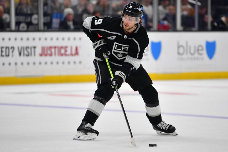 Dec 30, 2023; Los Angeles, California, USA; Los Angeles Kings right wing Adrian Kempe (9) controls the puck against the Edmonton Oilers during the overtime period at Crypto.com Arena. Mandatory Credit: Gary A. Vasquez-USA TODAY Sports