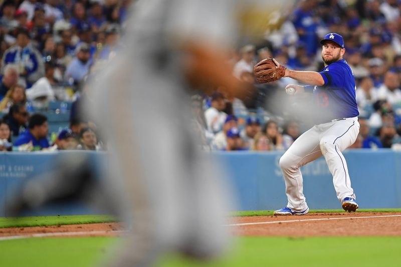 Jul 6, 2023; Los Angeles, California, USA; Los Angeles Dodgers third baseman Max Muncy (13) throws to first for the out against Pittsburgh Pirates shortstop Nick Gonzales (39) during the fifth inning at Dodger Stadium. Mandatory Credit: Gary A. Vasquez-USA TODAY Sports