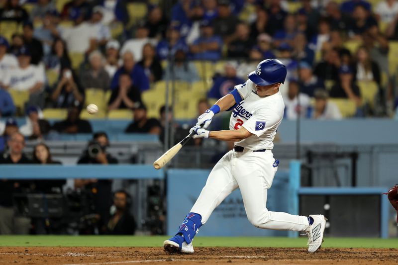 Sep 11, 2024; Los Angeles, California, USA;  Los Angeles Dodgers center fielder Tommy Edman (25) hits a 2-run home run during the eighth inning against the Chicago Cubs at Dodger Stadium. Mandatory Credit: Kiyoshi Mio-Imagn Images