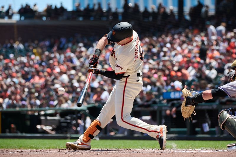 May 19, 2024; San Francisco, California, USA; San Francisco Giants outfielder Mike Yastrzemski (5) hits a single against the Colorado Rockies during the second inning at Oracle Park. Mandatory Credit: Robert Edwards-USA TODAY Sports