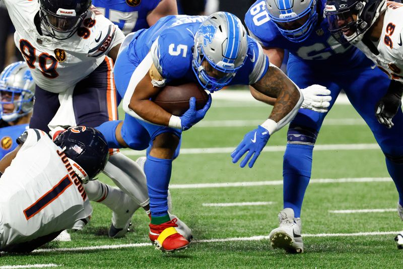 Detroit Lions running back David Montgomery (5) rushes against the Chicago Bears in the first half of an NFL football game in Detroit, Thursday, Nov. 28, 2024. (AP Photo/Rick Osentoski)