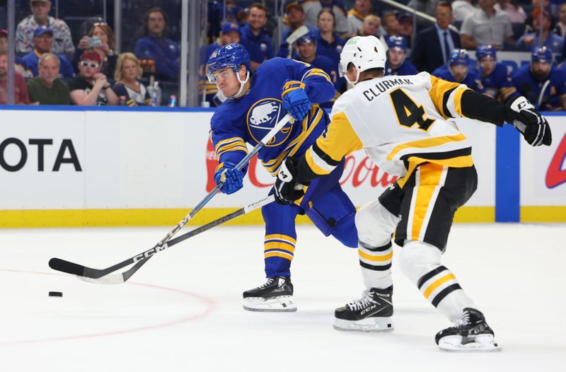 Sep 21, 2024; Buffalo, New York, USA;  Buffalo Sabres right wing Nicolas Aube-Kubel (96) takes a shot on goal as Pittsburgh Penguins defenseman Nathan Clurman (4) defends during the second period at KeyBank Center. Mandatory Credit: Timothy T. Ludwig-Imagn Images