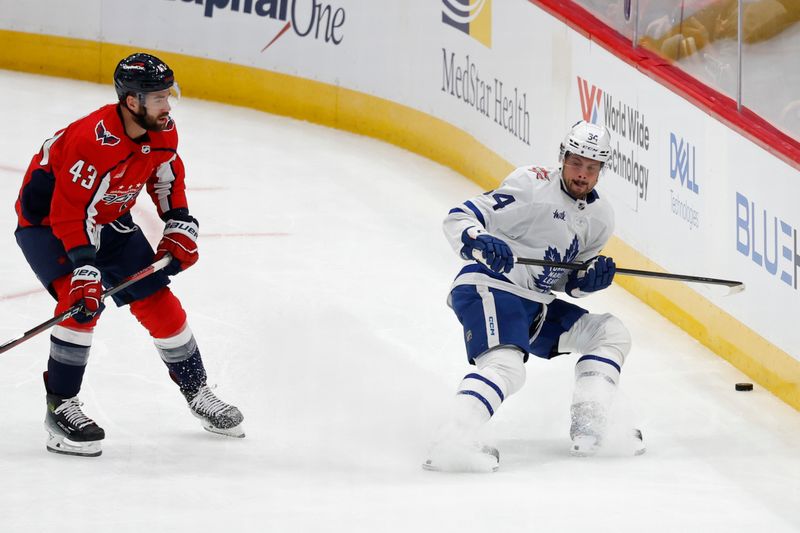 Oct 24, 2023; Washington, District of Columbia, USA; Toronto Maple Leafs center Auston Matthews (34) skates with the puck as Washington Capitals right wing Tom Wilson (43) chase in the first period at Capital One Arena. Mandatory Credit: Geoff Burke-USA TODAY Sports