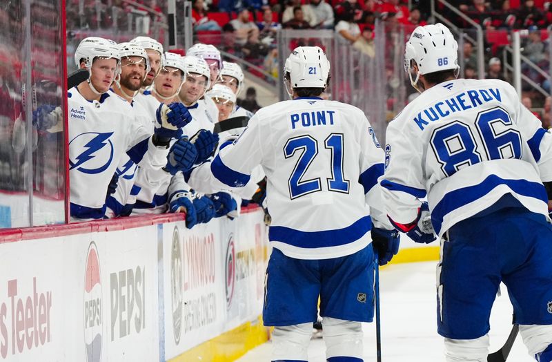 Oct 11, 2024; Raleigh, North Carolina, USA;  Tampa Bay Lightning center Brayden Point (21) celebrates scoring a goal against the Carolina Hurricanes during the second period at PNC Arena. Mandatory Credit: James Guillory-Imagn Images