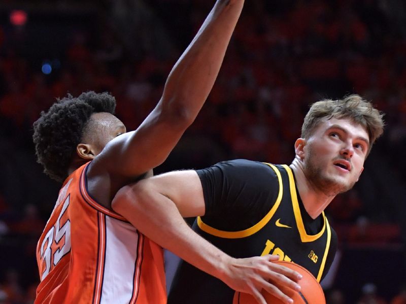 Feb 24, 2024; Champaign, Illinois, USA;  Iowa Hawkeyes forward Owen Freeman (32) drives to the basket as Illinois Fighting Illini forward Amani Hansberry (35) defends during the second half at State Farm Center. Mandatory Credit: Ron Johnson-USA TODAY Sports