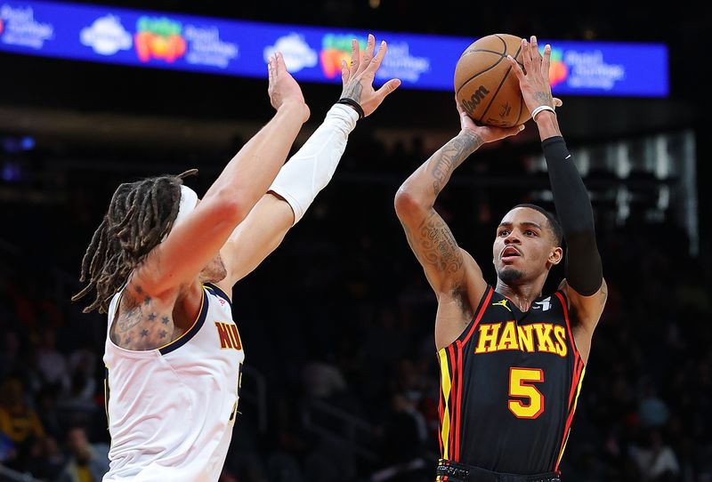 ATLANTA, GEORGIA - DECEMBER 11:  Dejounte Murray #5 of the Atlanta Hawks shoots against Aaron Gordon #50 of the Denver Nuggets during the fourth quarter at State Farm Arena on December 11, 2023 in Atlanta, Georgia.  NOTE TO USER: User expressly acknowledges and agrees that, by downloading and/or using this photograph, user is consenting to the terms and conditions of the Getty Images License Agreement.  (Photo by Kevin C. Cox/Getty Images)