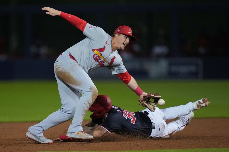 Mar 8, 2024; West Palm Beach, Florida, USA; Washington Nationals outfielder Jacob Young (30) slides safely behind the tag of St. Louis Cardinals second baseman Nolan Gorman (16) while stealing second base in the second inning at CACTI Park of the Palm Beaches. Mandatory Credit: Jim Rassol-USA TODAY Sports