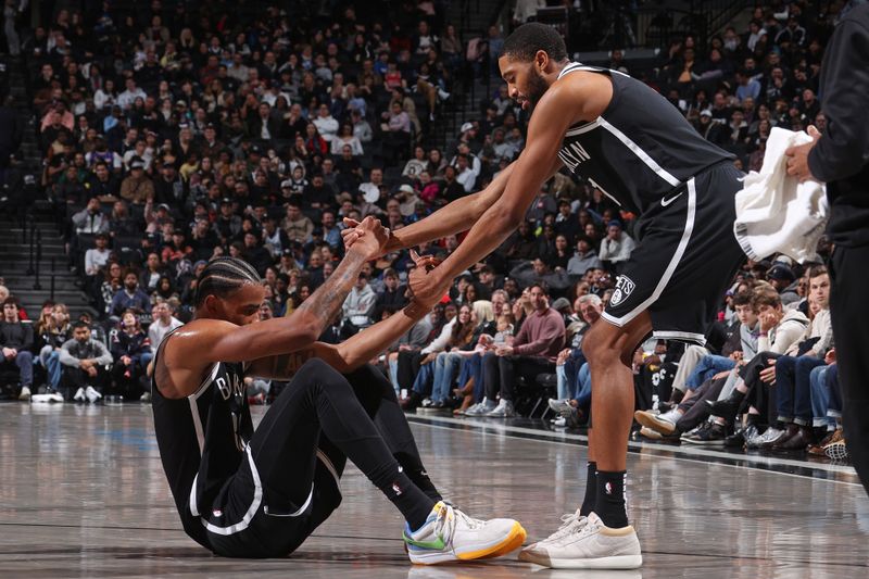 BROOKLYN, NY - MARCH 2: Mikal Bridges #1 of the Brooklyn Nets helps up Nicolas Claxton #33 during the game against the Atlanta Hawks on March 2, 2024 at Barclays Center in Brooklyn, New York. NOTE TO USER: User expressly acknowledges and agrees that, by downloading and or using this Photograph, user is consenting to the terms and conditions of the Getty Images License Agreement. Mandatory Copyright Notice: Copyright 2024 NBAE (Photo by Nathaniel S. Butler/NBAE via Getty Images)