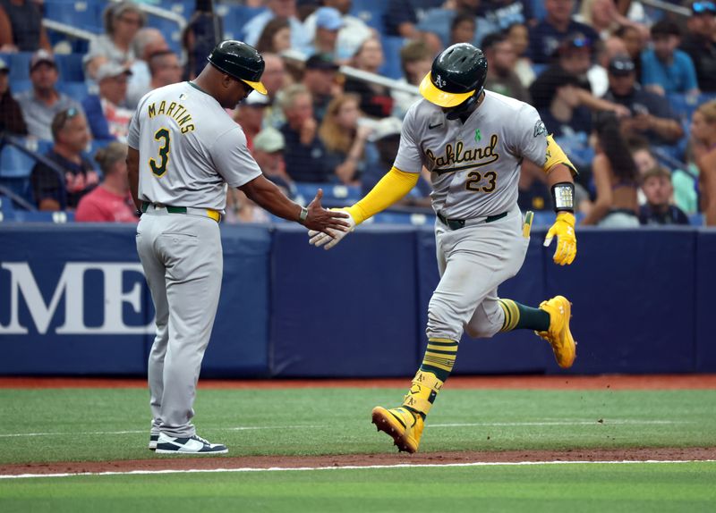 May 30, 2024; St. Petersburg, Florida, USA; Oakland Athletics catcher Shea Langeliers (23) is congratulated by third base coach Eric Martins (3) after hitting a two-run home run against the Tampa Bay Rays during the third inning at Tropicana Field. Mandatory Credit: Kim Klement Neitzel-USA TODAY Sports