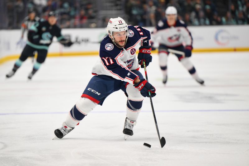 Nov 12, 2024; Seattle, Washington, USA; Columbus Blue Jackets right wing Justin Danforth (17) advances the puck against the Seattle Kraken during the second period at Climate Pledge Arena. Mandatory Credit: Steven Bisig-Imagn Images