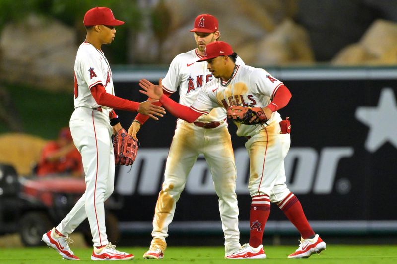 Sep 17, 2024; Anaheim, California, USA;  Los Angeles Angels center fielder Jordyn Adams (39), left fielder Taylor Ward (3) and right fielder Gustavo Campero (51) shake hands as they come off the field after the final out of the ninth inning against the Chicago White Sox at Angel Stadium. Mandatory Credit: Jayne Kamin-Oncea-Imagn Images