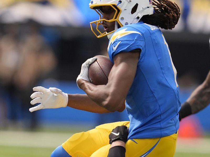 Los Angeles Chargers wide receiver Quentin Johnston, top, is tackled by Las Vegas Raiders linebacker Robert Spillane during the second half of an NFL football game, Sunday, Sept. 8, 2024, in Inglewood, Calif. (AP Photo/Marcio Jose Sanchez)