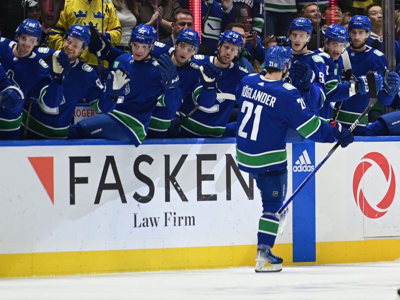 Mar 23, 2024; Vancouver, British Columbia, CAN; Vancouver Canucks forward Nils Hoglander (21) celebrates a goal against Calgary Flames during the first period at Rogers Arena. Mandatory Credit: Simon Fearn-USA TODAY Sports